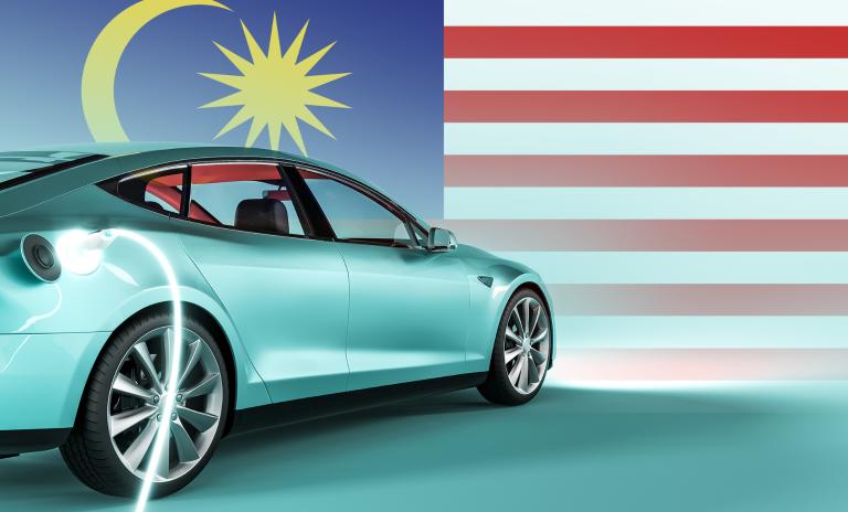 image of an electric car against the background of the Malaysian flag