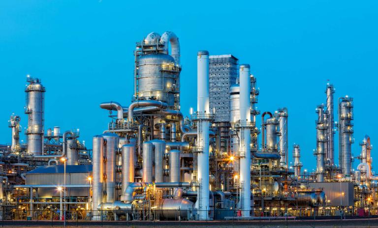 A large, modern petrochemical plant at dusk.