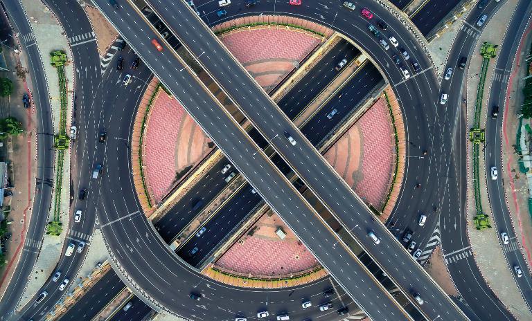 Auto vehicles driving through highway lanes in a Southeast Asian country