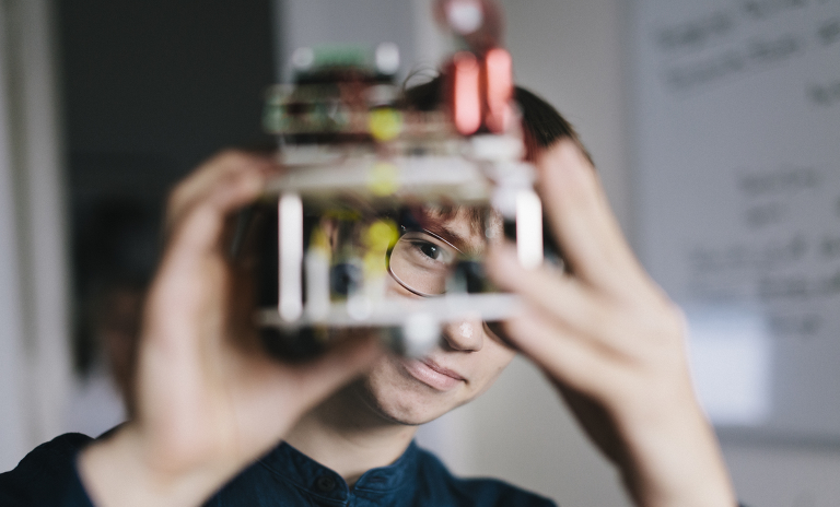 Man looking through a mechanical device