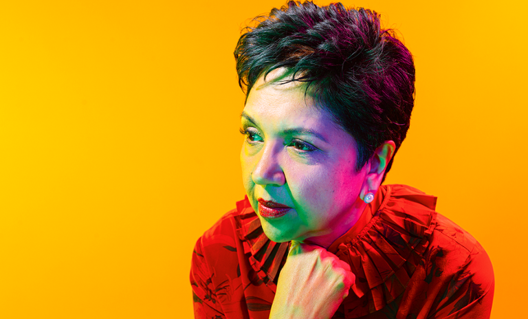 A photograph of Indra Nooyi, the former CEO of PepsiCo, looking into the distance.