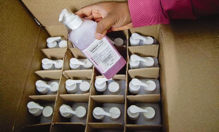 Bulk purchase of locally produced products, like this antiseptic alcohol hand rub, enable NH to reduce its daily expenses.