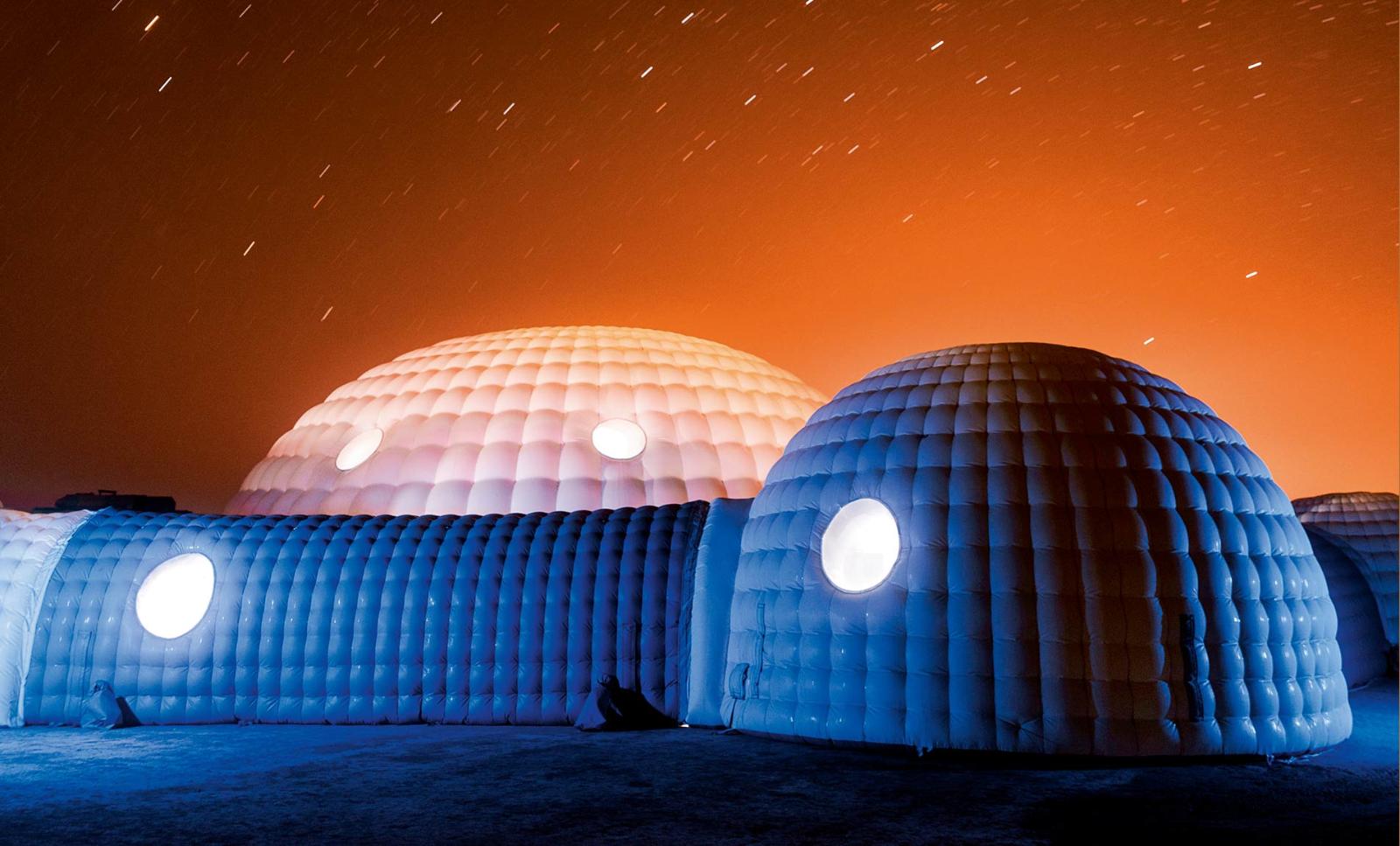 The sky behind Kepler Station glows orange from local oil processing plants