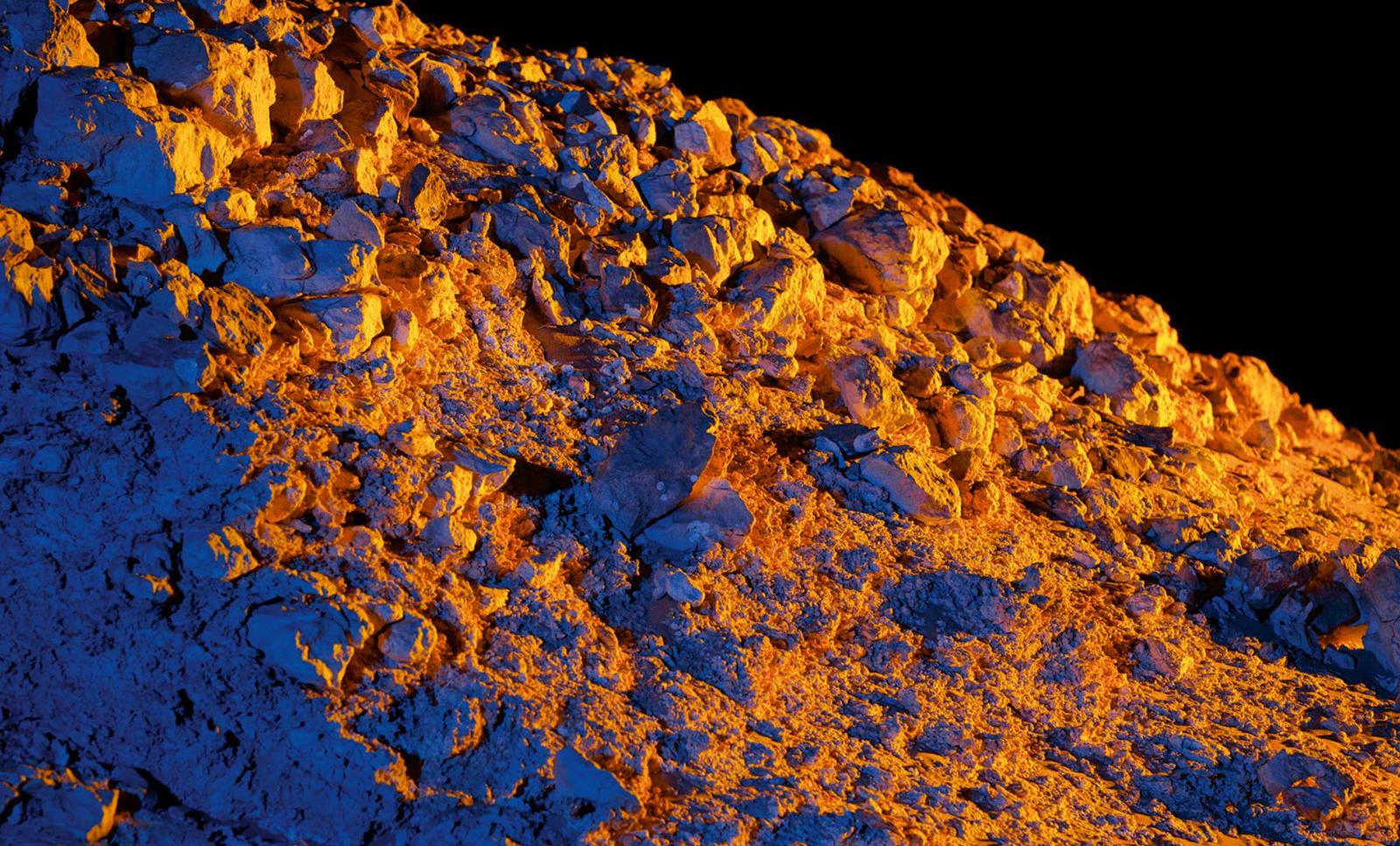 A close up of the Oman desert terrain glowing orange and blue