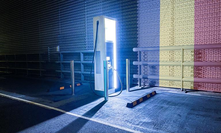 Electric charging station for cars with the flag of Romania on the background.