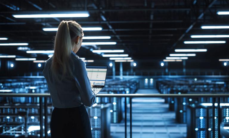 Data center IT specialist uses laptop