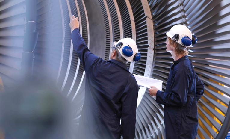 Two engineers inspecting industrial production