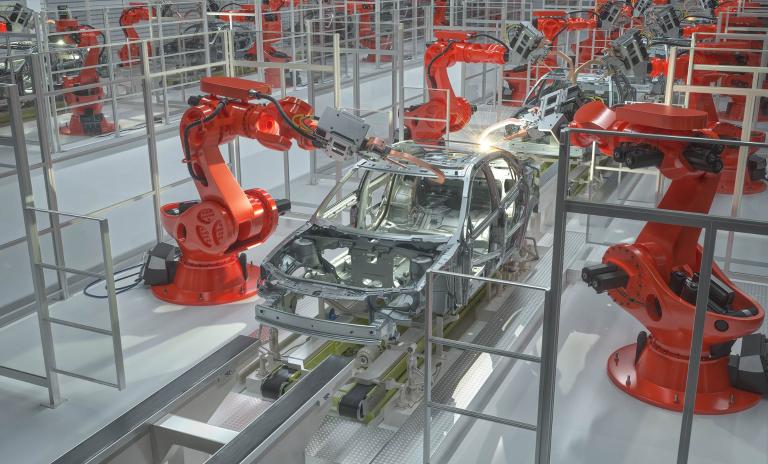 Industrial Robots Welding Car Body In Car Factory.