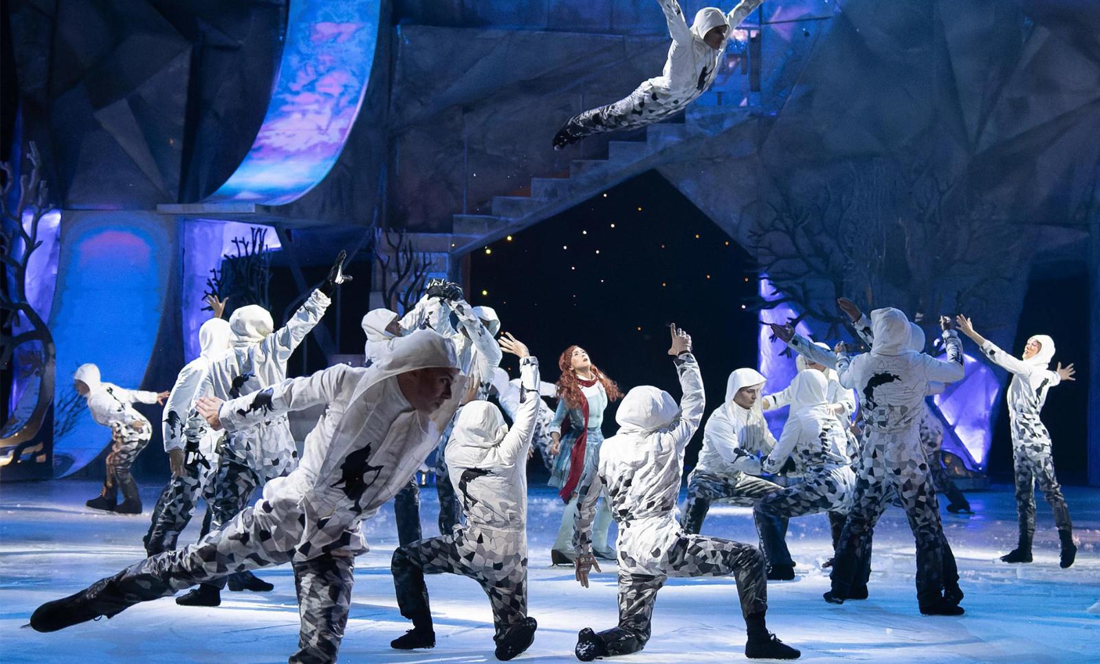 world-class ice skaters and acrobats are performing gravity-defying feats over a sheet of ice.