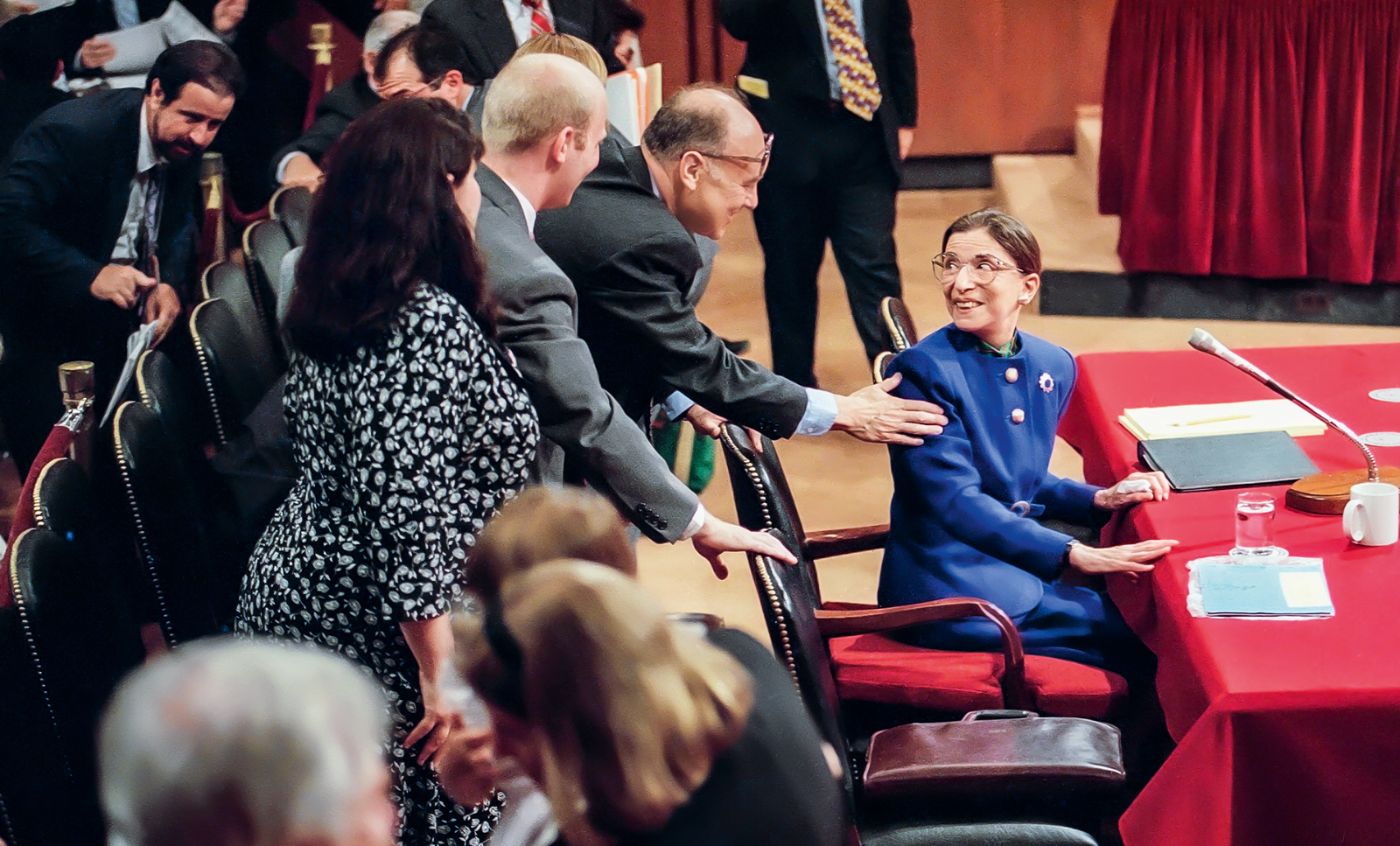 Ruth Bader Ginsburg turns around. Her husband Martin greets her by putting his hand on her shoulder during her 1993 confirmation hearing before the Senate Judiciary Committee. (c) AP Photo/John Durick/DPA