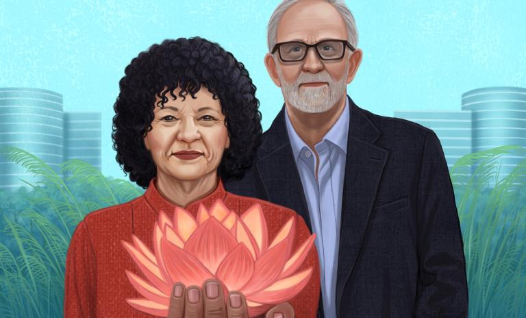 Freada Kapor Klein, illustrated wearing a dark red blouse, holding a lotus flower in an outstretched left hand, Mitch Kapor, wearing a dark blue suit jacket and pale blue shirt, standing beside her. Pale blue background with green fine reeds and outlines of towers at either side of Kapor and Kapor Klein.