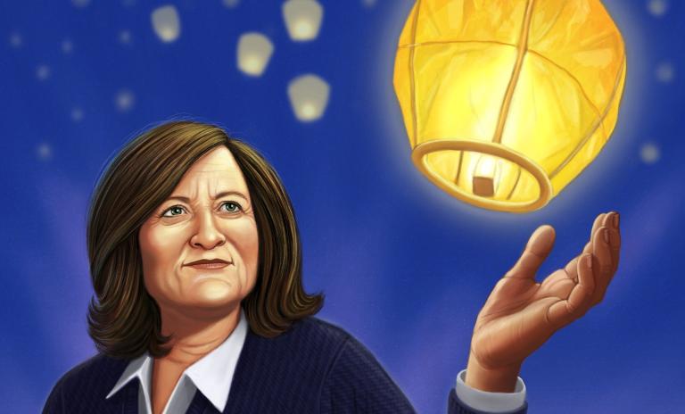 Rose Marcario illustrated wearing a navy V-neck jumper over a white shirt, lit Chinese lantern above her outstretched hand as if she had just let it go. Indigo blue background to suggest night sky with blurred smaller Chinese lanterns flying in the distance behind Marcario.