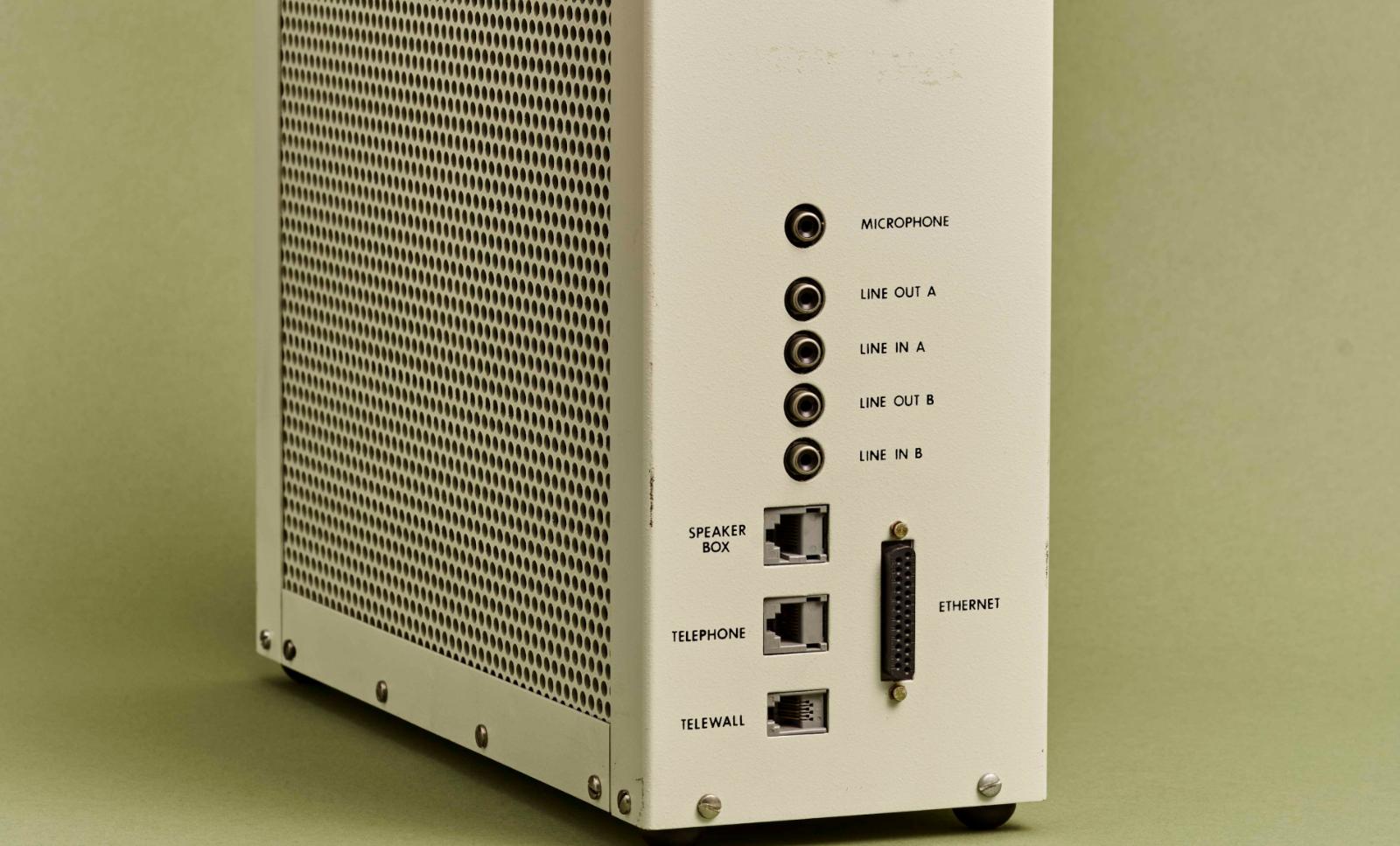 A close-up image of an old Etherphone device. Green-grey background.