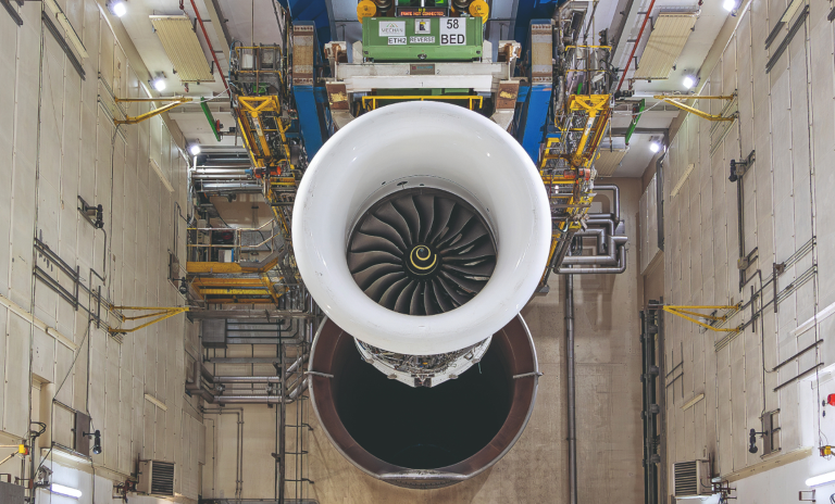 Airplane engine in an industrial workshop positioned for testing sustainable aviation fuel.