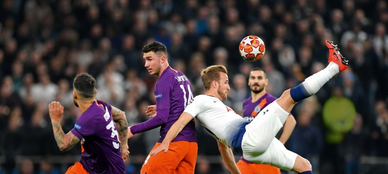 Tottenham Hotspur striker Harry Cane kicks a football over his head during match play