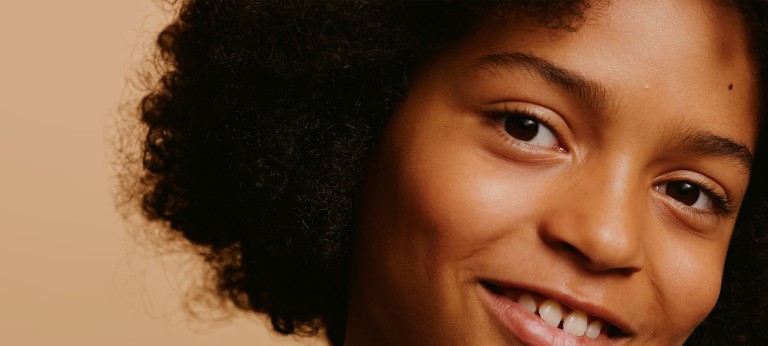 A close-up photo showing the front teeth of a smiling child.